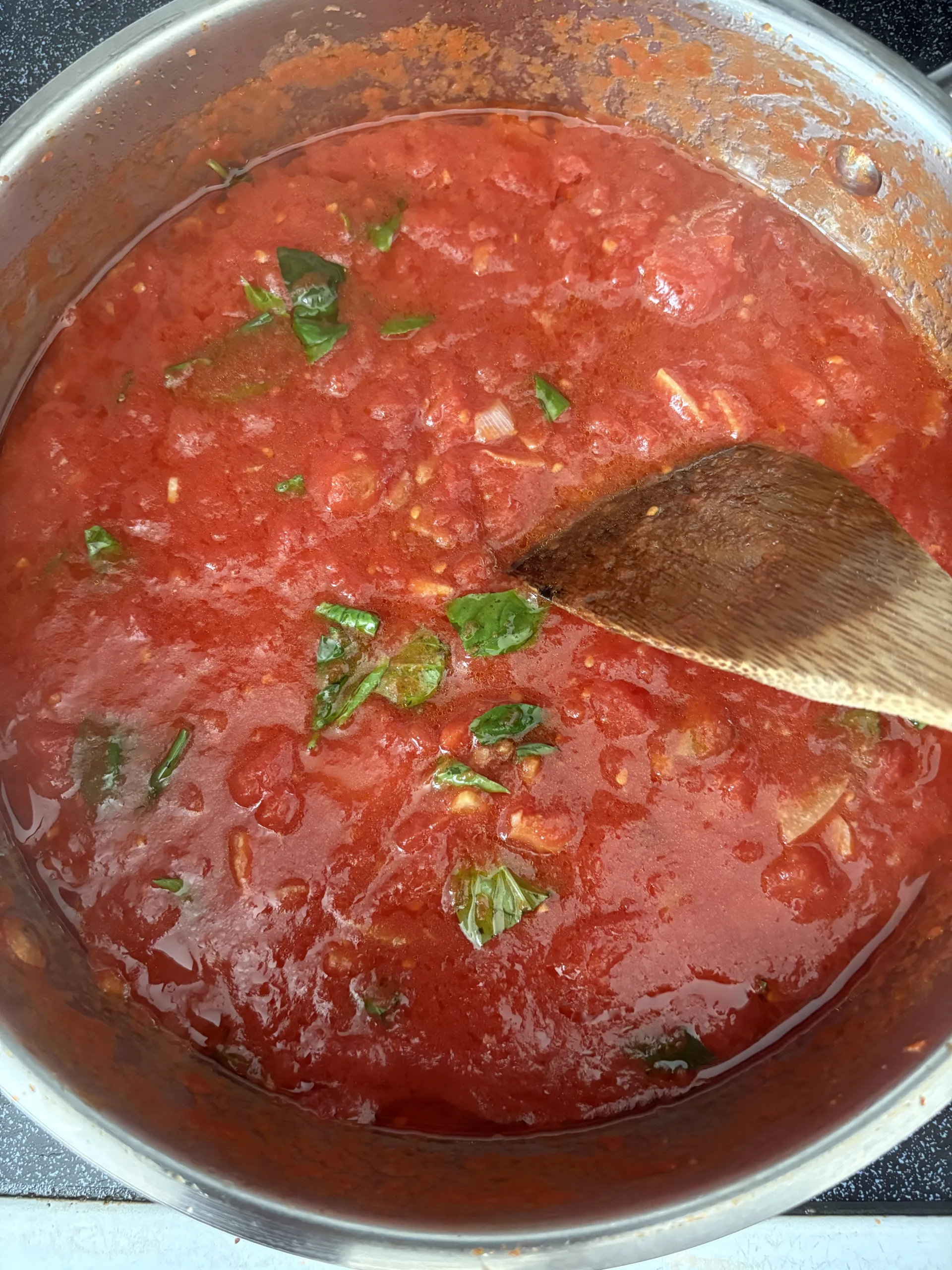 A simple Italian tomato sauce and basil in a pan.