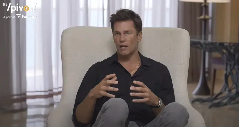 Tom Brady speaking during an interview, gesturing with his hands